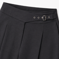 Detalle de hebilla y cintura del pantalón negro